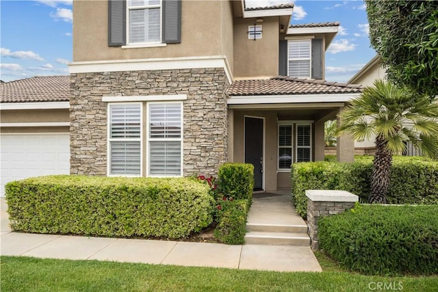 23911 Brio Ct, Valencia, CA 91354 - view of exterior entry with stucco siding, stone siding, and a tile roof