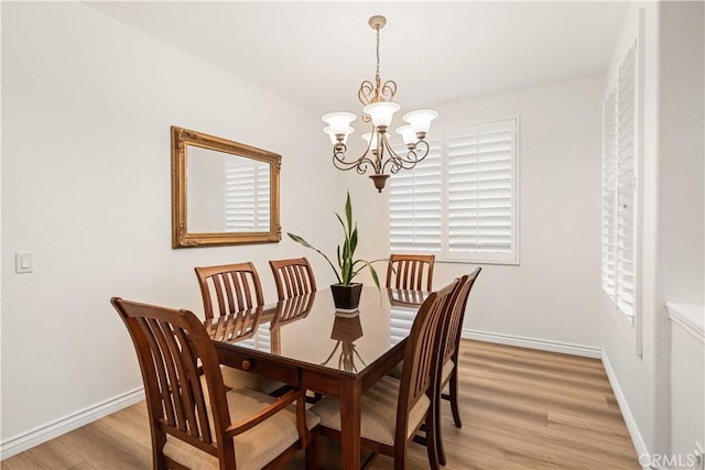 23911 Brio Ct, Valencia, CA 91354 - dining space with a chandelier, light wood-style flooring, and baseboards