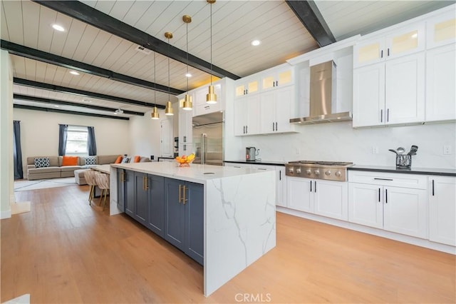 451 Avenida Esplendor, Walnut, CA 91789 - kitchen with stainless steel appliances, wall chimney exhaust hood, beam ceiling, white cabinetry, and light wood-type flooring