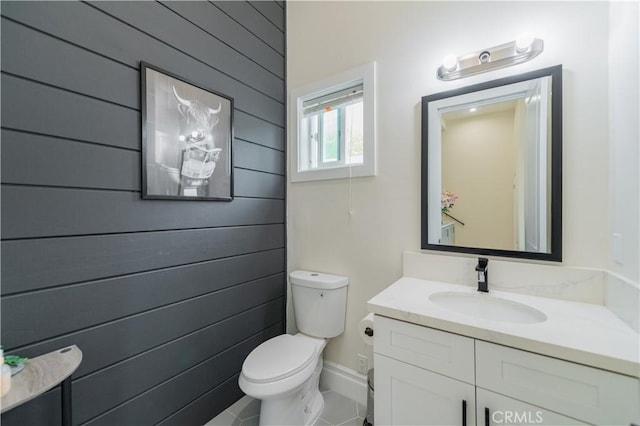 451 Avenida Esplendor, Walnut, CA 91789 - half bathroom with toilet, vanity, tile patterned flooring, and wood walls