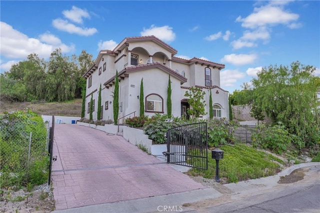 451 Avenida Esplendor, Walnut, CA 91789 - mediterranean / spanish-style home featuring fence, stucco siding, a gate, and a tile roof