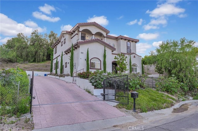 451 Avenida Esplendor, Walnut, CA 91789 - mediterranean / spanish-style house featuring stucco siding, a gate, and a tiled roof