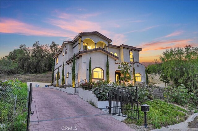 451 Avenida Esplendor, Walnut, CA 91789 - mediterranean / spanish house featuring stucco siding, a gate, and a tiled roof