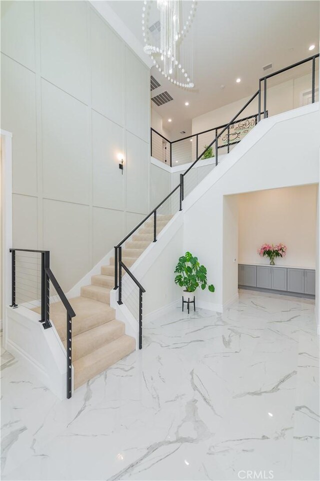 451 Avenida Esplendor, Walnut, CA 91789 - stairway featuring a high ceiling, marble tiled floors, a chandelier, baseboards, and recessed lighting