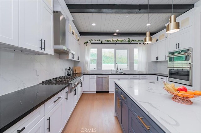 451 Avenida Esplendor, Walnut, CA 91789 - kitchen with appliances with stainless steel finishes, wall chimney range hood, a sink, beam ceiling, and white cabinetry
