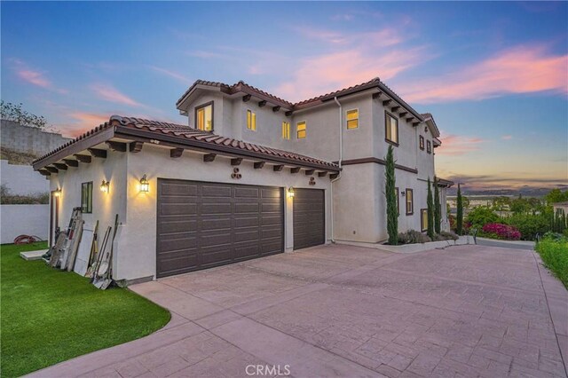451 Avenida Esplendor, Walnut, CA 91789 - mediterranean / spanish-style home featuring driveway, stucco siding, a tiled roof, a front lawn, and a garage