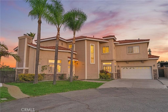 338 Calle Vis, Walnut, CA 91789 - mediterranean / spanish house featuring stone siding, stucco siding, driveway, an attached garage, and a tiled roof