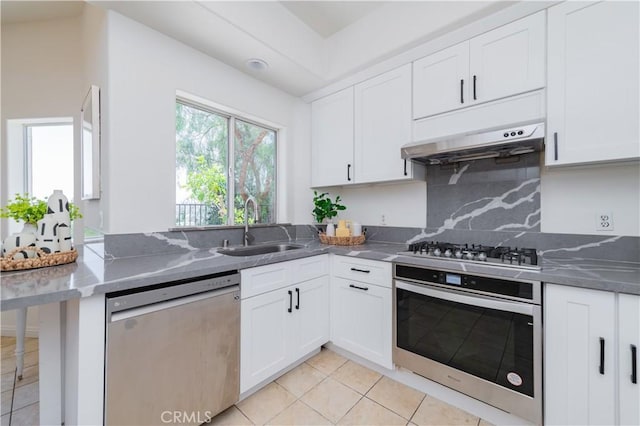 338 Calle Vis, Walnut, CA 91789 - kitchen featuring stainless steel appliances, white cabinets, dark stone counters, light tile patterned flooring, and backsplash