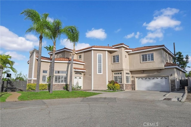 338 Calle Vis, Walnut, CA 91789 - view of front of property featuring stone siding, concrete driveway, stucco siding, and a garage