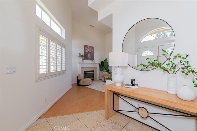338 Calle Vis, Walnut, CA 91789 - entrance foyer featuring light tile patterned floors, a high ceiling, and a glass covered fireplace