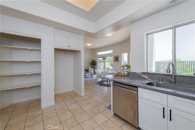 338 Calle Vis, Walnut, CA 91789 - kitchen with stainless steel dishwasher, white cabinets, dark countertops, and light tile patterned floors