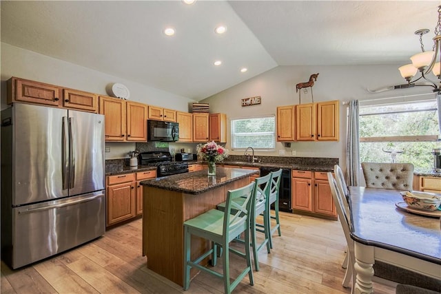 3263 Green Canyon Rd, Fallbrook, CA 92028 - kitchen with black appliances, vaulted ceiling, a center island, recessed lighting, and a breakfast bar