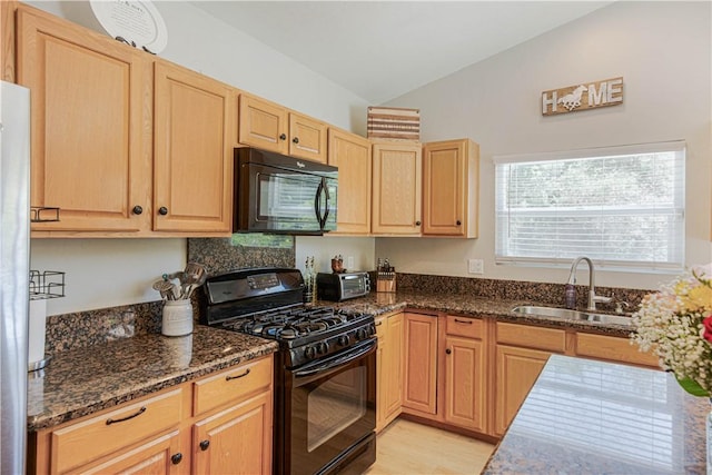 3263 Green Canyon Rd, Fallbrook, CA 92028 - kitchen with black appliances, a sink, vaulted ceiling, light brown cabinetry, and dark stone counters