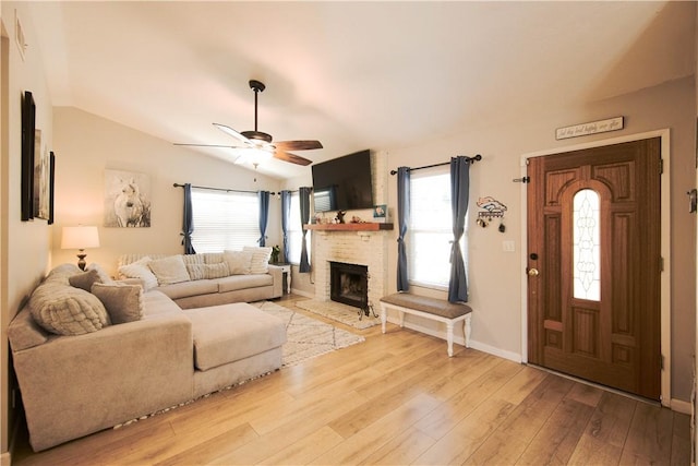 3263 Green Canyon Rd, Fallbrook, CA 92028 - living area with light wood finished floors, a ceiling fan, vaulted ceiling, healthy amount of natural light, and a fireplace