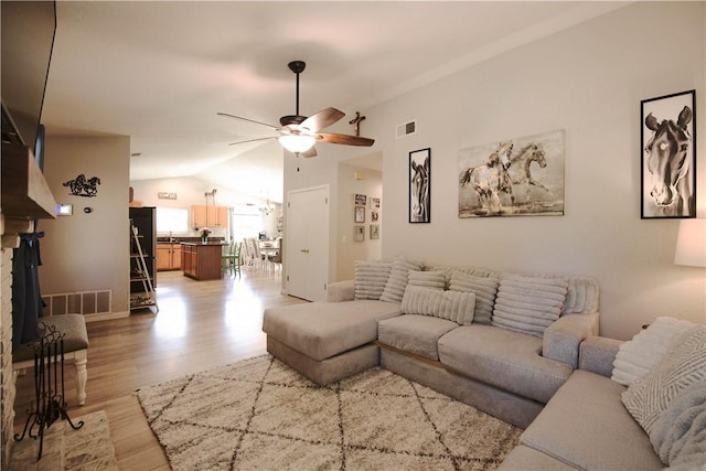 3263 Green Canyon Rd, Fallbrook, CA 92028 - living room featuring a ceiling fan, vaulted ceiling, and light wood-style flooring