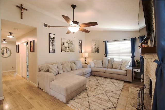 3263 Green Canyon Rd, Fallbrook, CA 92028 - living room featuring vaulted ceiling, ceiling fan, light wood-style floors, a brick fireplace, and baseboards