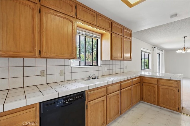 442 R St, Merced, CA 95341 - kitchen featuring dishwasher, tasteful backsplash, a sink, a peninsula, and a textured ceiling
