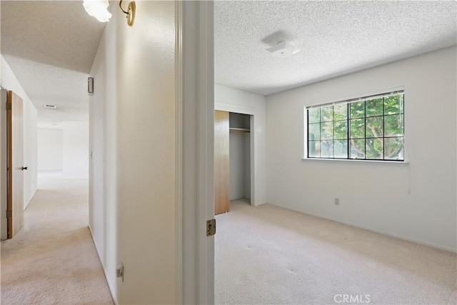 442 R St, Merced, CA 95341 - unfurnished bedroom with carpet flooring, a closet, and a textured ceiling