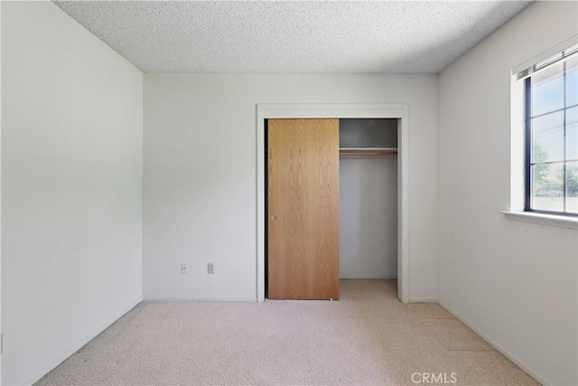 442 R St, Merced, CA 95341 - unfurnished bedroom with carpet floors, a closet, a textured ceiling, and baseboards