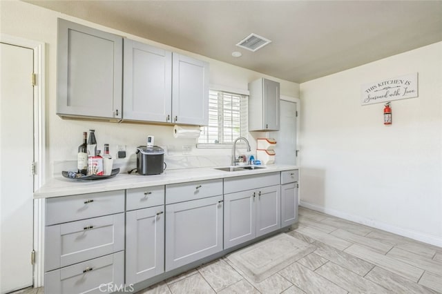 15025 Avenida Ramada, Desert Hot Springs, CA 92240 - kitchen with a sink, gray cabinets, and light countertops