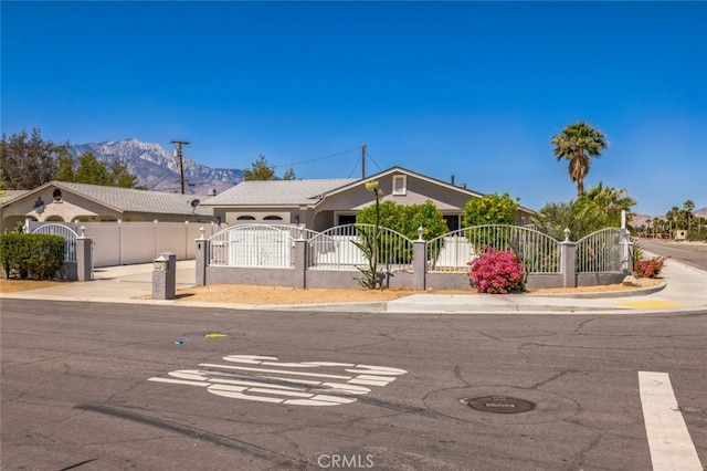 15025 Avenida Ramada, Desert Hot Springs, CA 92240 - ranch-style home featuring a fenced front yard, a mountain view, and a gate