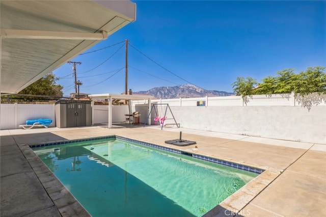 15025 Avenida Ramada, Desert Hot Springs, CA 92240 - view of pool with a patio, a mountain view, and a fenced backyard