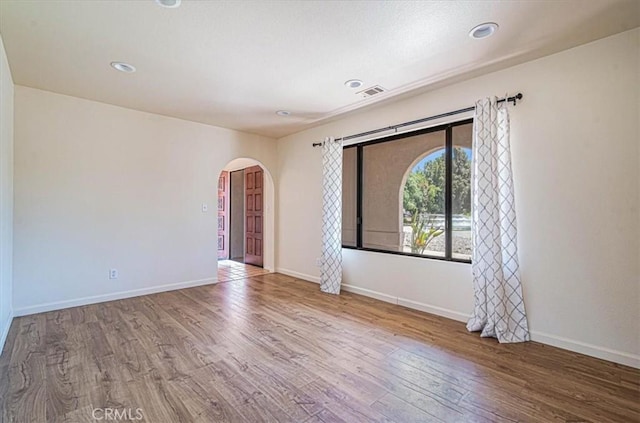 420 Via Vicente, Nipomo, CA 93444 - empty room with arched walkways, wood finished floors, baseboards, and recessed lighting