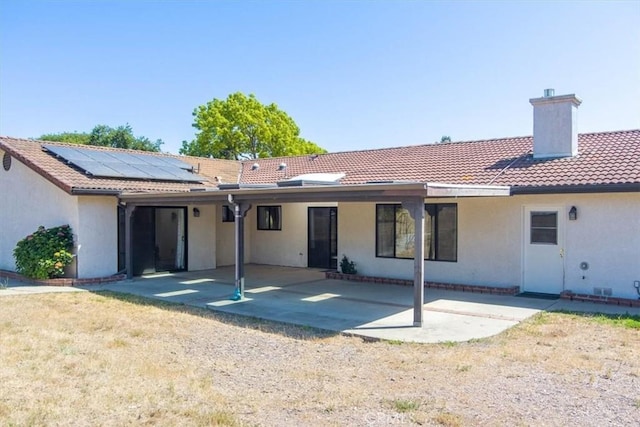 420 Via Vicente, Nipomo, CA 93444 - rear view of house with stucco siding, a chimney, a tiled roof, a patio, and roof mounted solar panels