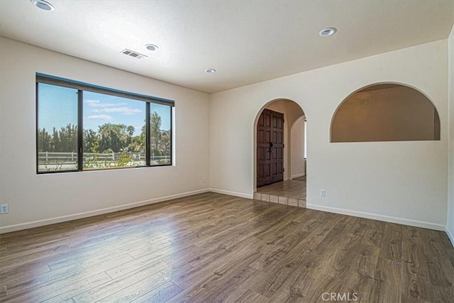 420 Via Vicente, Nipomo, CA 93444 - spare room featuring arched walkways, wood finished floors, baseboards, and recessed lighting