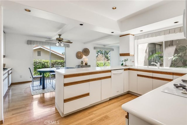 27005 Diamondhead Ln, Rancho Palos Verdes, CA 90275 - kitchen with light wood-type flooring, white appliances, a peninsula, ceiling fan, and white cabinets