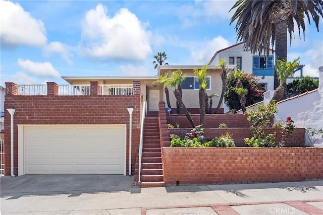 2021 Elanita Dr, San Pedro, CA 90732 - view of front of property with stairs, driveway, a garage, and brick siding