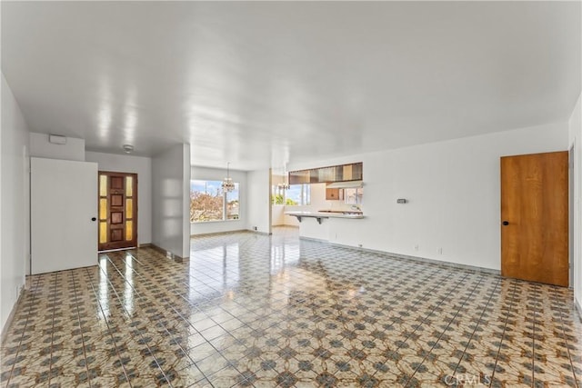 2021 Elanita Dr, San Pedro, CA 90732 - unfurnished living room with a chandelier and baseboards