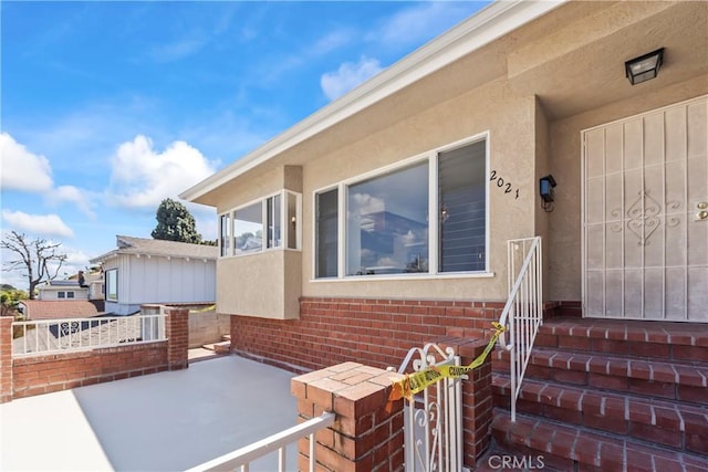 2021 Elanita Dr, San Pedro, CA 90732 - view of exterior entry featuring brick siding and stucco siding