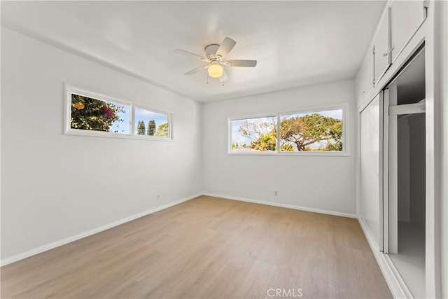 2021 Elanita Dr, San Pedro, CA 90732 - unfurnished bedroom featuring multiple windows, light wood-type flooring, baseboards, and a closet