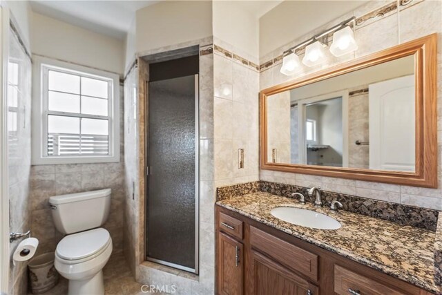 2021 Elanita Dr, San Pedro, CA 90732 - bathroom with tile walls, healthy amount of natural light, vanity, toilet, and tile patterned floors