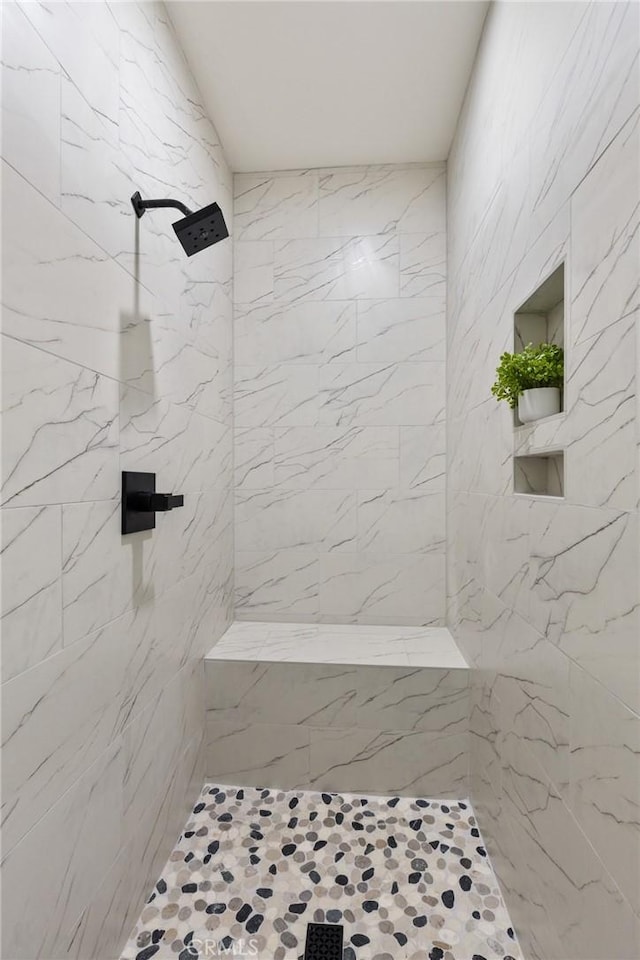 full bath with a tile shower