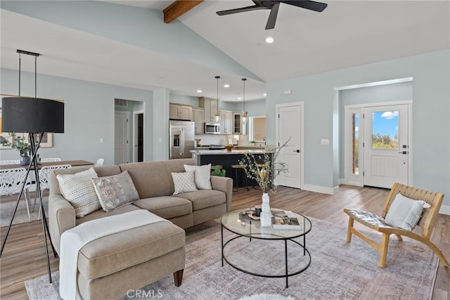 living area with light wood-style flooring, a ceiling fan, recessed lighting, and baseboards