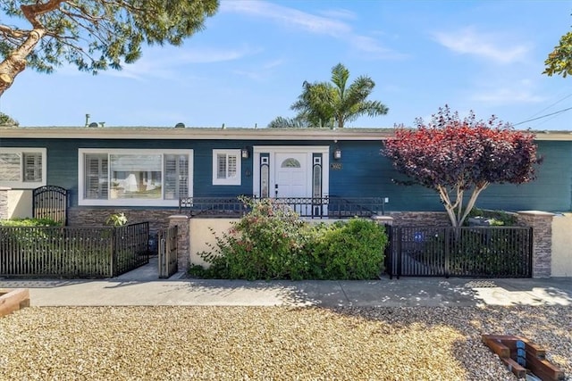 3602 S Walker Ave, San Pedro, CA 90731 - ranch-style home with stone siding, a gate, and a fenced front yard