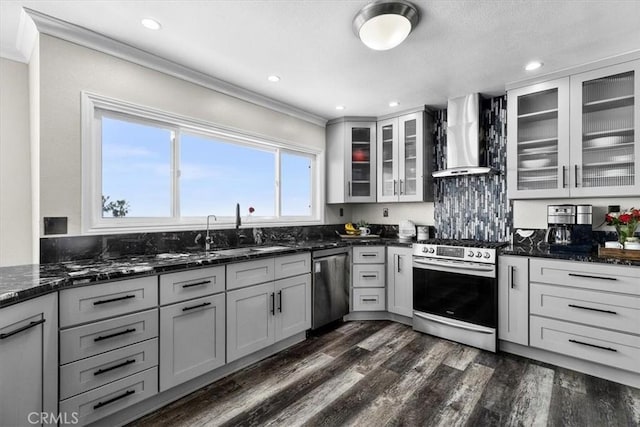 3602 S Walker Ave, San Pedro, CA 90731 - kitchen featuring wall chimney exhaust hood, stainless steel appliances, crown molding, a sink, and dark wood-type flooring