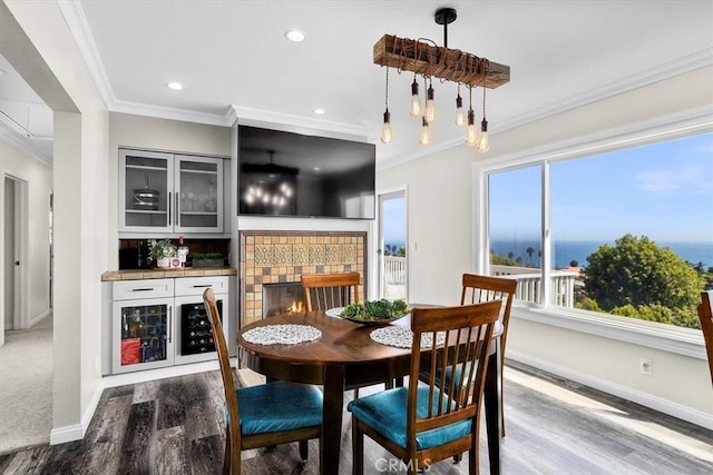 3602 S Walker Ave, San Pedro, CA 90731 - dining room with crown molding, wood finished floors, baseboards, recessed lighting, and a tile fireplace