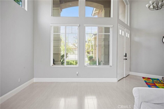 2 Corte Lateuza, Lake Elsinore, CA 92532 - foyer entrance with plenty of natural light, baseboards, wood finished floors, and a chandelier
