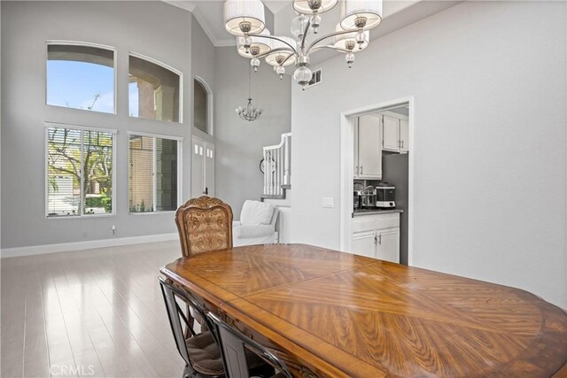 2 Corte Lateuza, Lake Elsinore, CA 92532 - dining space with a chandelier, wood finished floors, baseboards, stairs, and ornamental molding