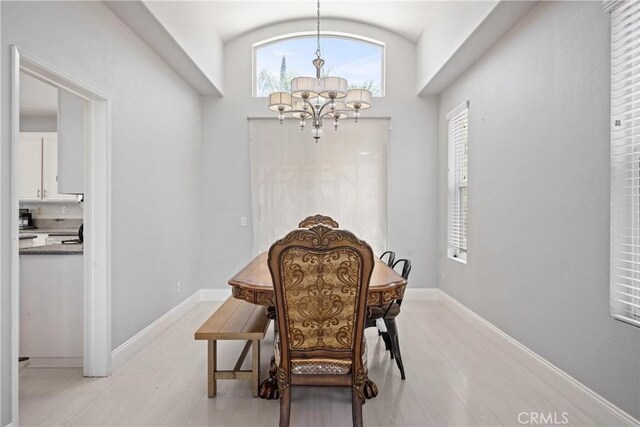 2 Corte Lateuza, Lake Elsinore, CA 92532 - dining room with a chandelier, light wood-style flooring, baseboards, and vaulted ceiling