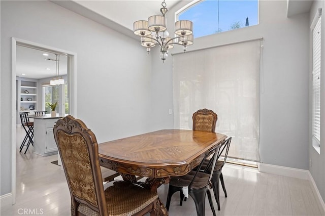 2 Corte Lateuza, Lake Elsinore, CA 92532 - dining space featuring a chandelier, baseboards, and light wood-style flooring