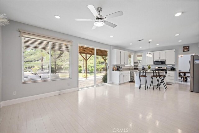 2 Corte Lateuza, Lake Elsinore, CA 92532 - kitchen with stainless steel appliances, a ceiling fan, white cabinetry, light wood-type flooring, and recessed lighting
