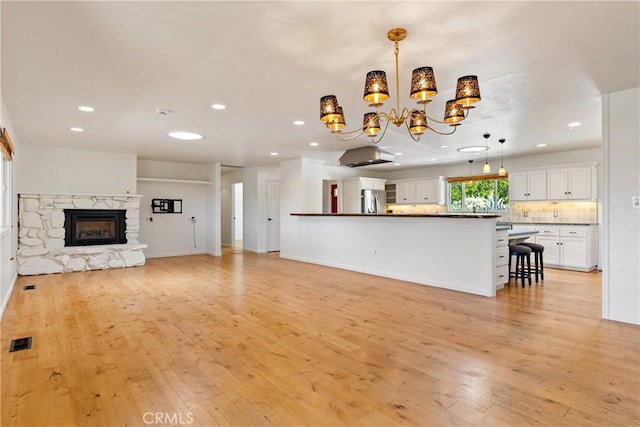 3500 Colima Rd, Atascadero, CA 93422 - unfurnished living room with a chandelier, recessed lighting, light wood-type flooring, a fireplace, and baseboards