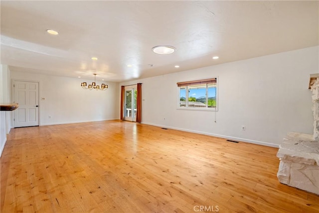 3500 Colima Rd, Atascadero, CA 93422 - unfurnished living room featuring a chandelier, light wood-type flooring, recessed lighting, baseboards, and a stone fireplace