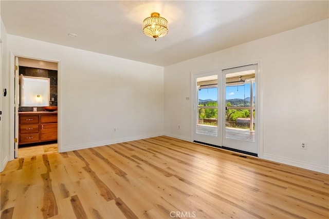 3500 Colima Rd, Atascadero, CA 93422 - empty room featuring baseboards, light wood finished floors, and a chandelier