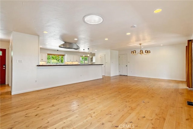 3500 Colima Rd, Atascadero, CA 93422 - unfurnished living room featuring a chandelier, light wood-style floors, recessed lighting, and baseboards