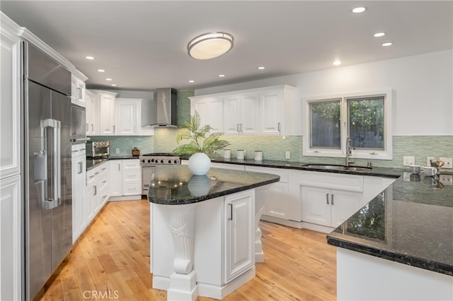 3828 Alomar Dr, Sherman Oaks, CA 91423 - kitchen with a sink, wall chimney range hood, high end appliances, white cabinets, and light wood-style flooring